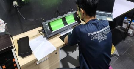 Certified technician performing Radiographic Testing (RT) film interpretation using digital imaging system at CT Precise Engineering Malaysia