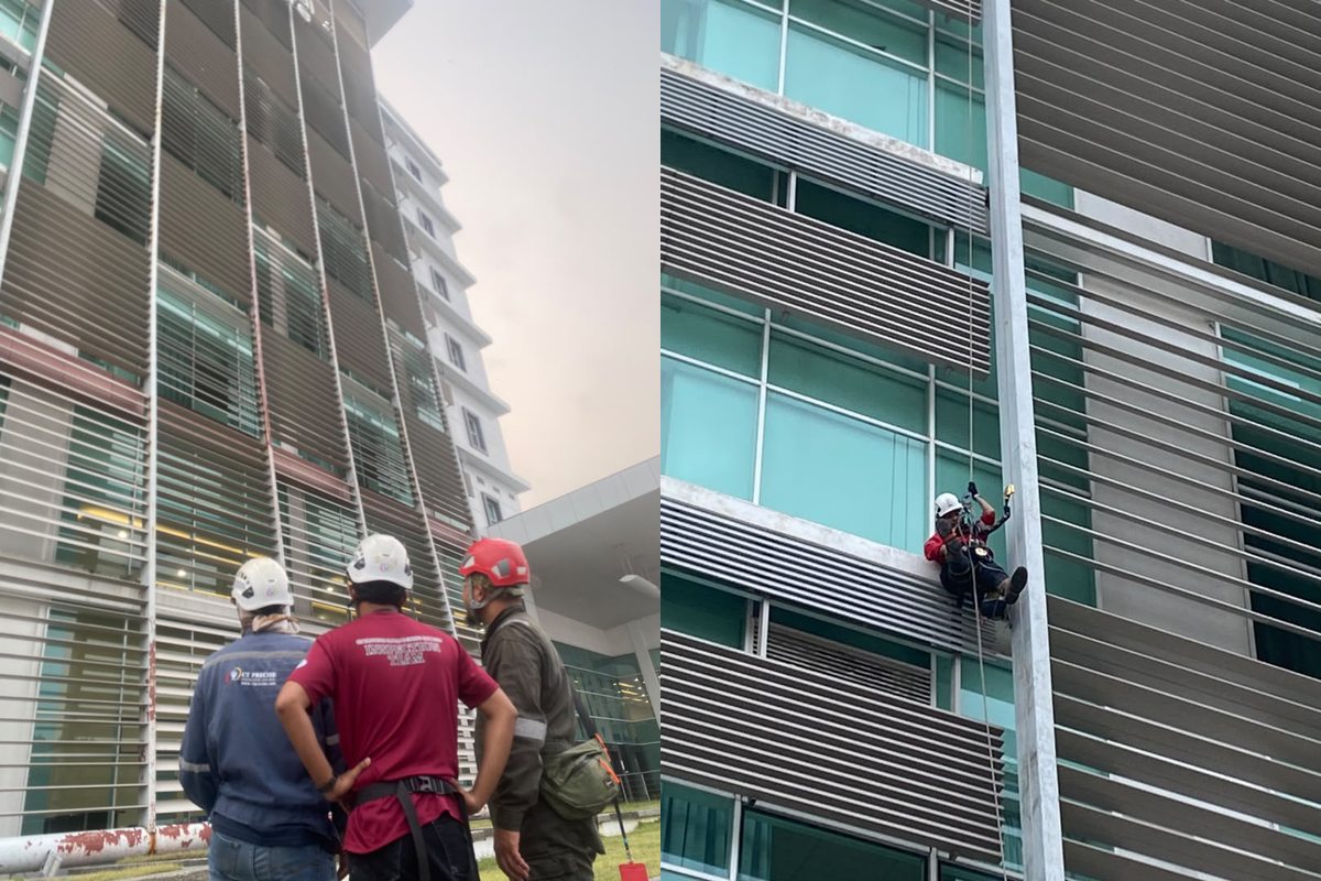 CT Precise inspection team and rope access technician examining hospital façade metalwork in Kuala Terengganu.